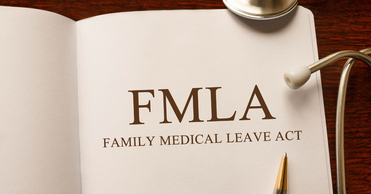 an image of a white document with the letters FMLA written on it on a brown desk background.